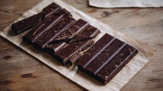 A bar of dark chocolate, one of the best weight loss foods, cut into slices
