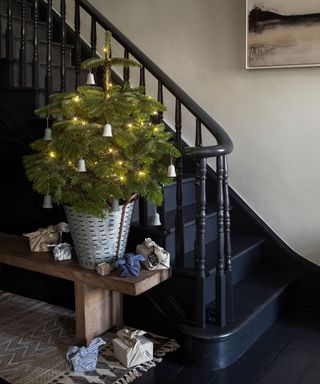 Painted wood staircase and hallway with Christmas tree