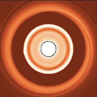 This simulated image shows the dust rings around a migrating exoplanet, with the small dust forming a ring interior to the planet and the large dust forming a ring on the outside of the planet.
