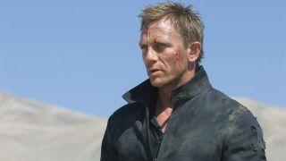 Daniel Craig standing in the desert, looking banged up, in Quantum of Solace.