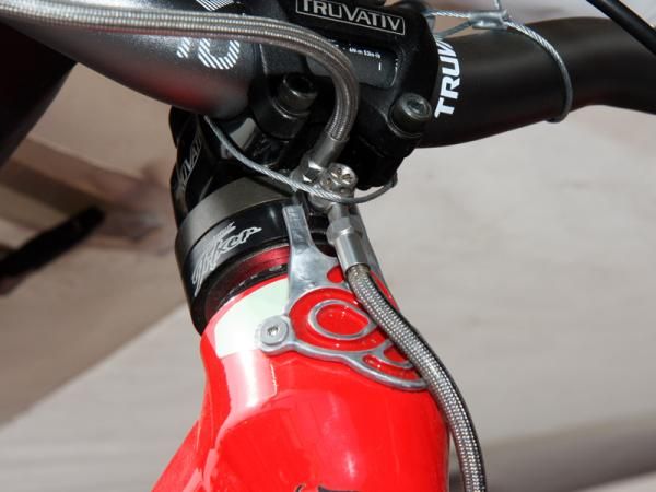 Brandon Semenuk's custom Trek Remedy uses a small plate to keep one half of his hydraulic cable detangler from spinning.