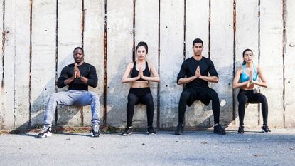 Athletic friends doing wall sits