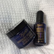 Kiehl's Midnight Recovery Cream and Concentrate on bedsheets 