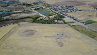 Birds-eye-view of the Gird-&icirc; Kazhaw archaeological site near a modern town.