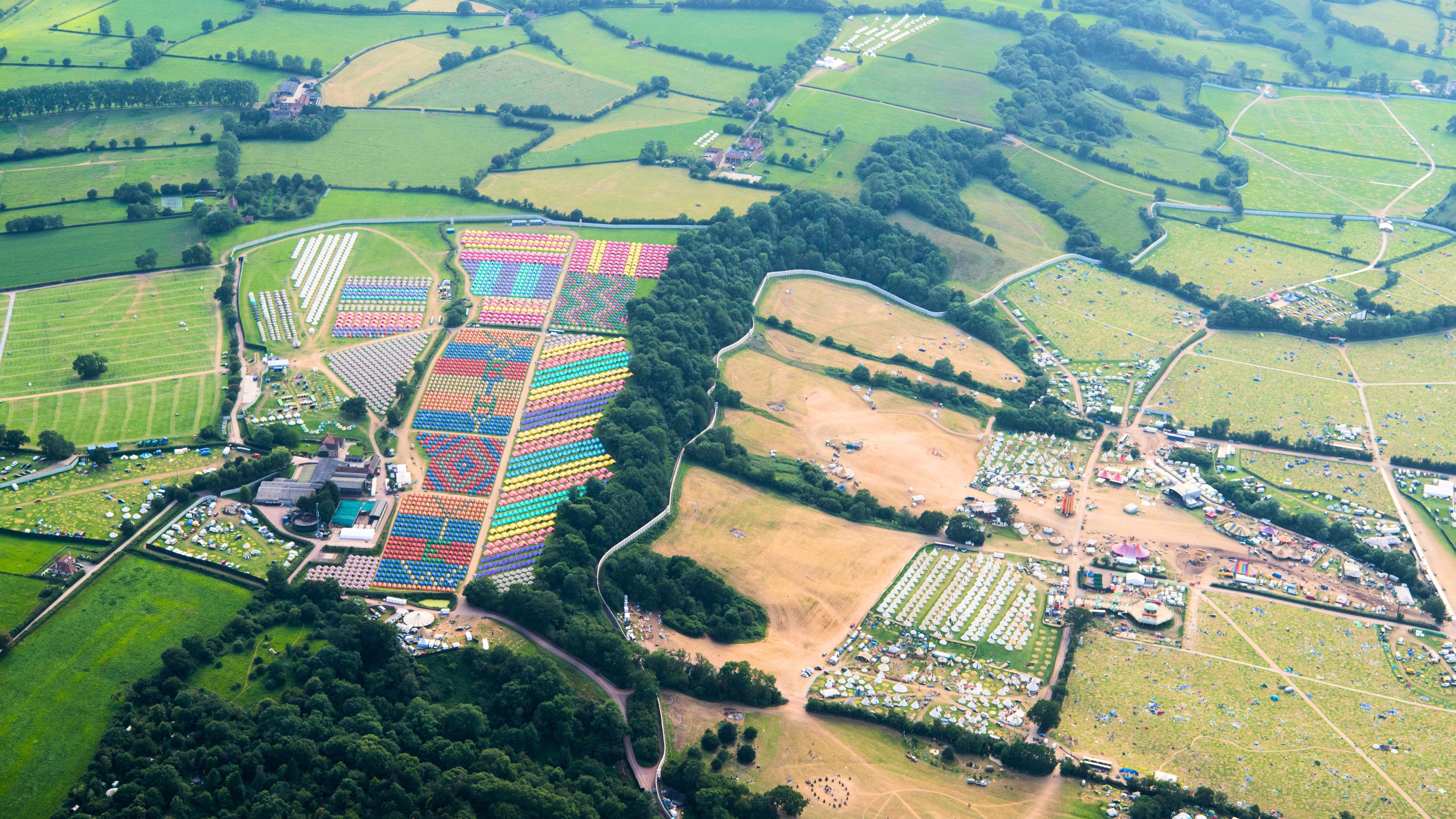 Aerial shot of Glastonbury&#039;s colorful tented campsite in Somerset