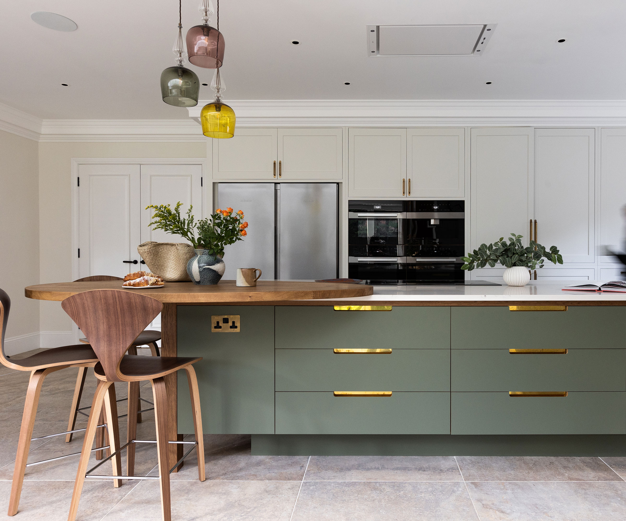 modern kitchen with sage green cabinets and rounded kitchen island