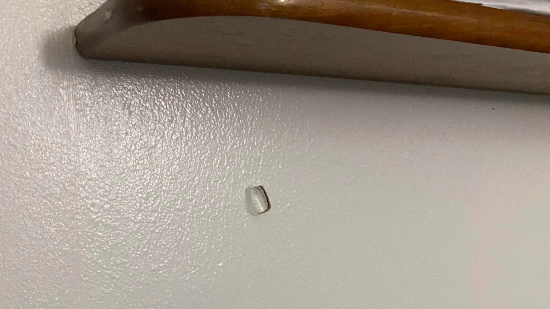 A dent left by a bullet that bounced off a Razer headset