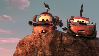 Two animated cars with eyes instead of windows are parked on top of a rock