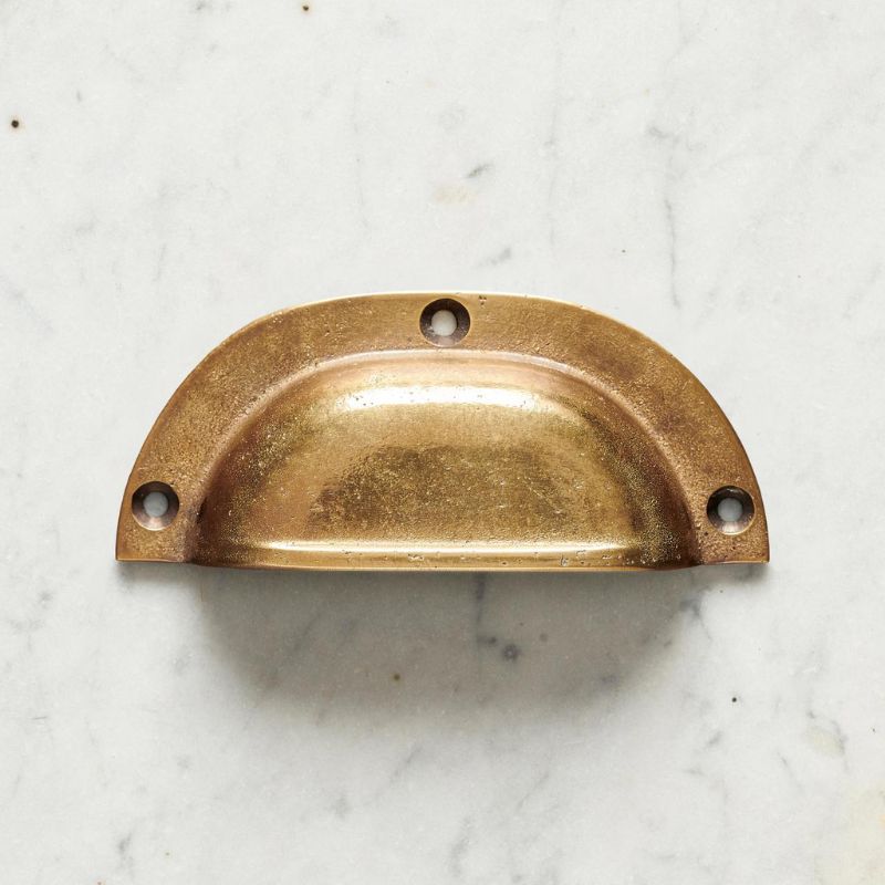 classic brass handle on white marble background