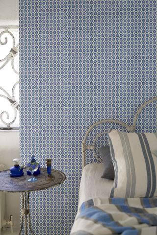 Blue and white pattern wall hanging, grey bed frame
