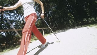 Woman walking with sticks, nordic walking