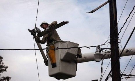 An electrical worker repairs a power line damaged by Hurricane Isaac in Arcola, La. Hundreds of thousands of Louisianans remain without power days after the slow-moving Category 1 hurricane p