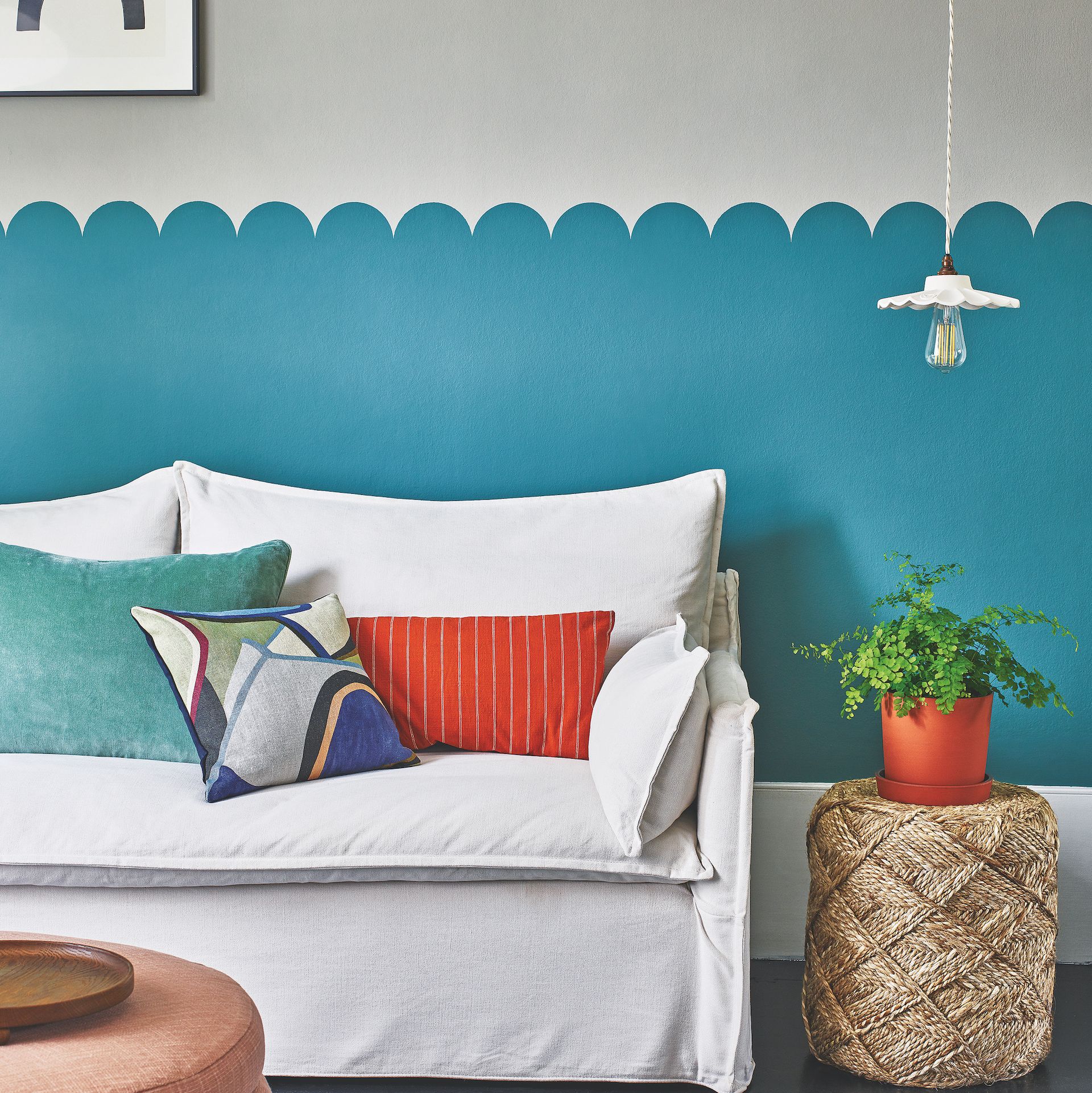 living room with patterned wall and sofa with cushions