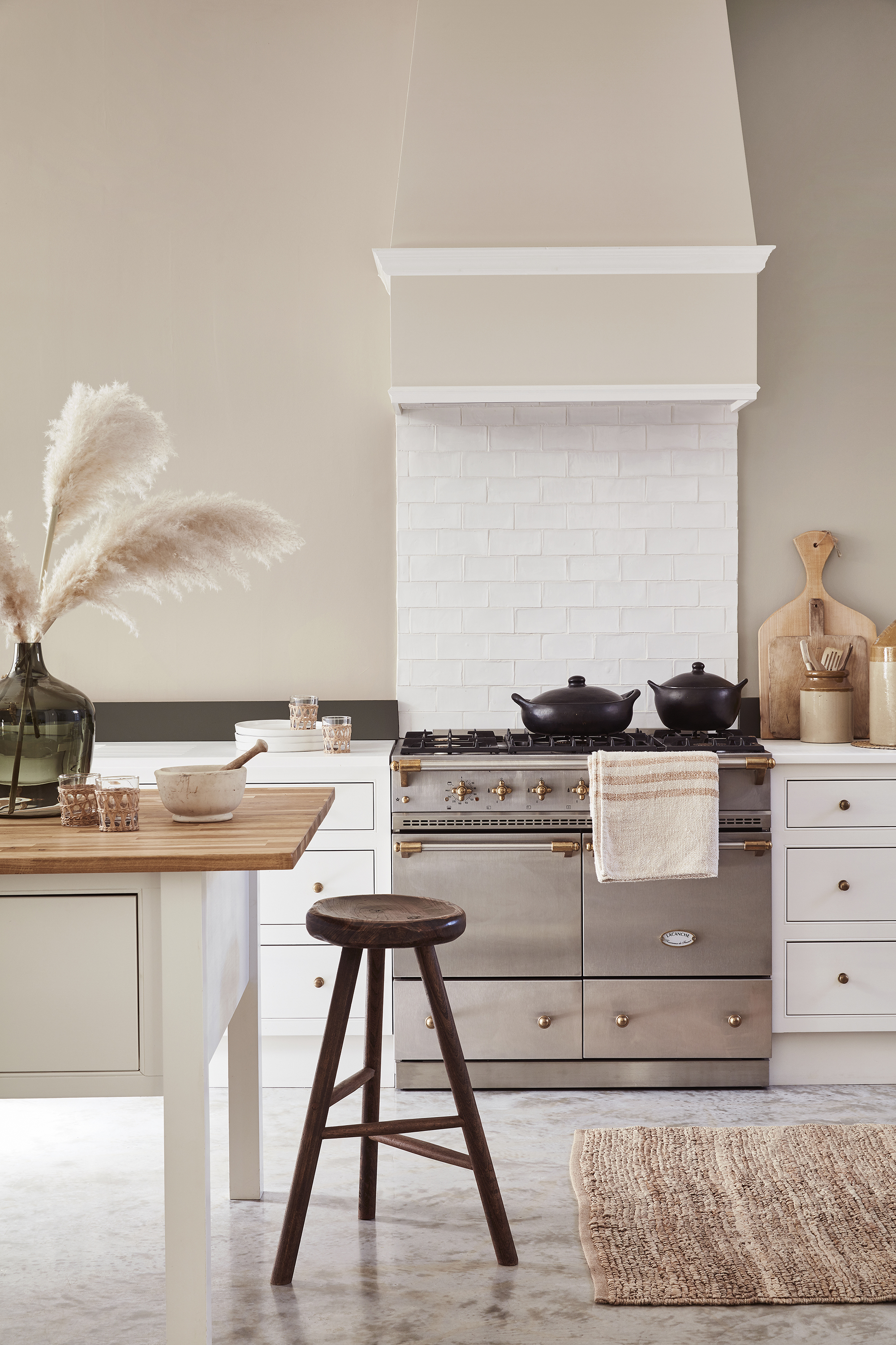 Light painted kitchen cabinet ideas in a pale beige scheme with marble flooring and white tiled backsplash.