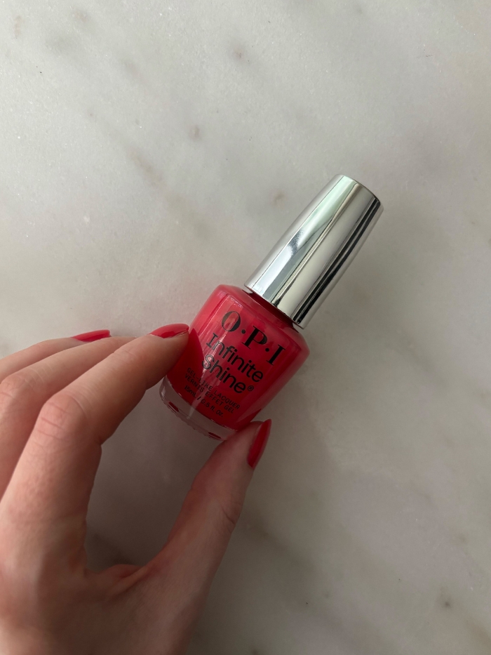 OPI Cajun Shrimp nail polish on a marble background