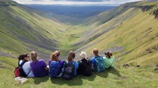 Walk and Talk Trust supporters take in the views of High Cup Nick in the North Pennines.JP