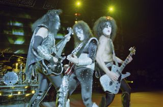 Ace Frehley (middle) performs onstage with Kiss