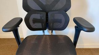 ThunderX3 chair set up in front of a white wall.