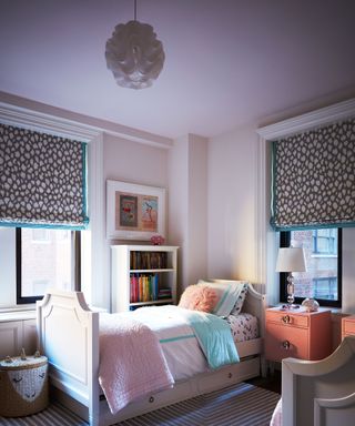 Purple bedroom with pastel decor surrounding bed