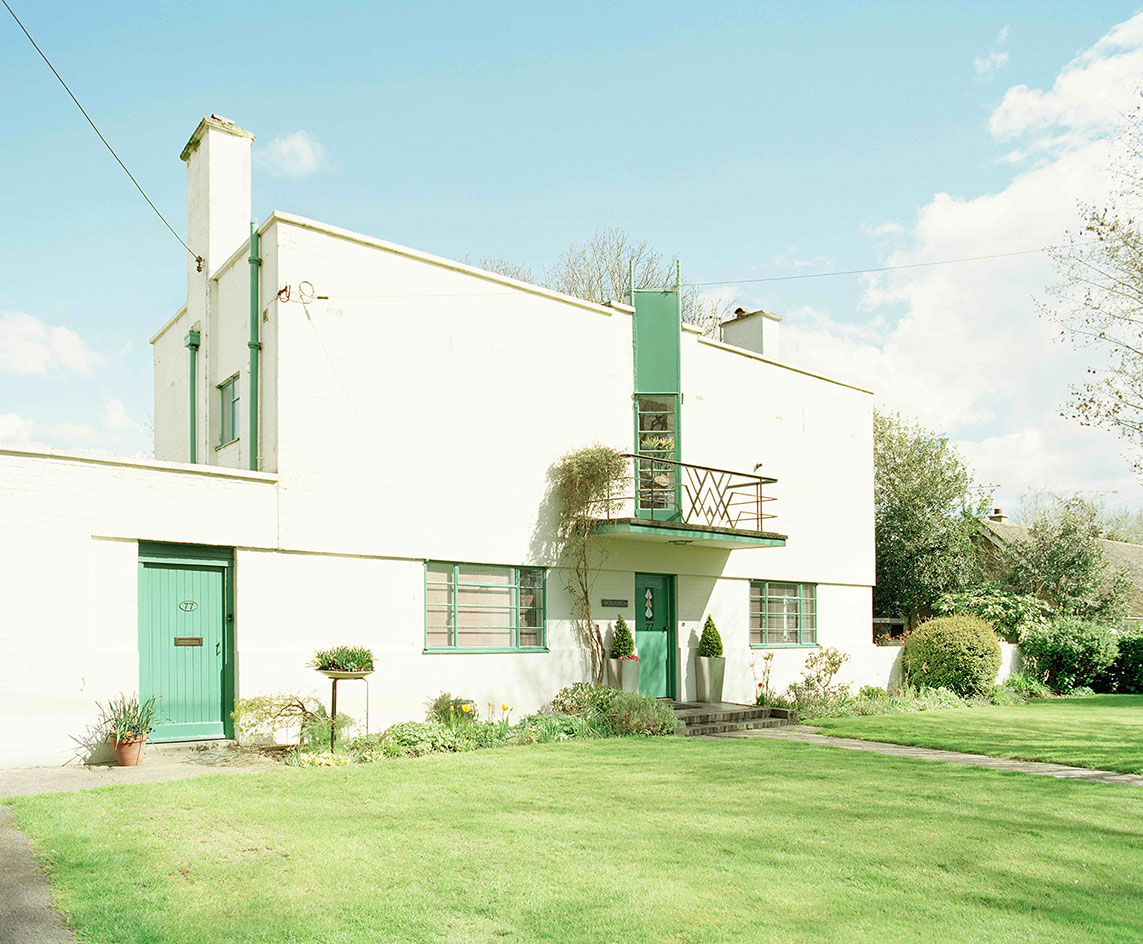 White & green home with well kept garden