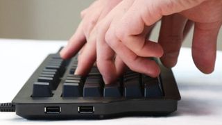 A pair of hands typing on a Das Keyboard Ultimate