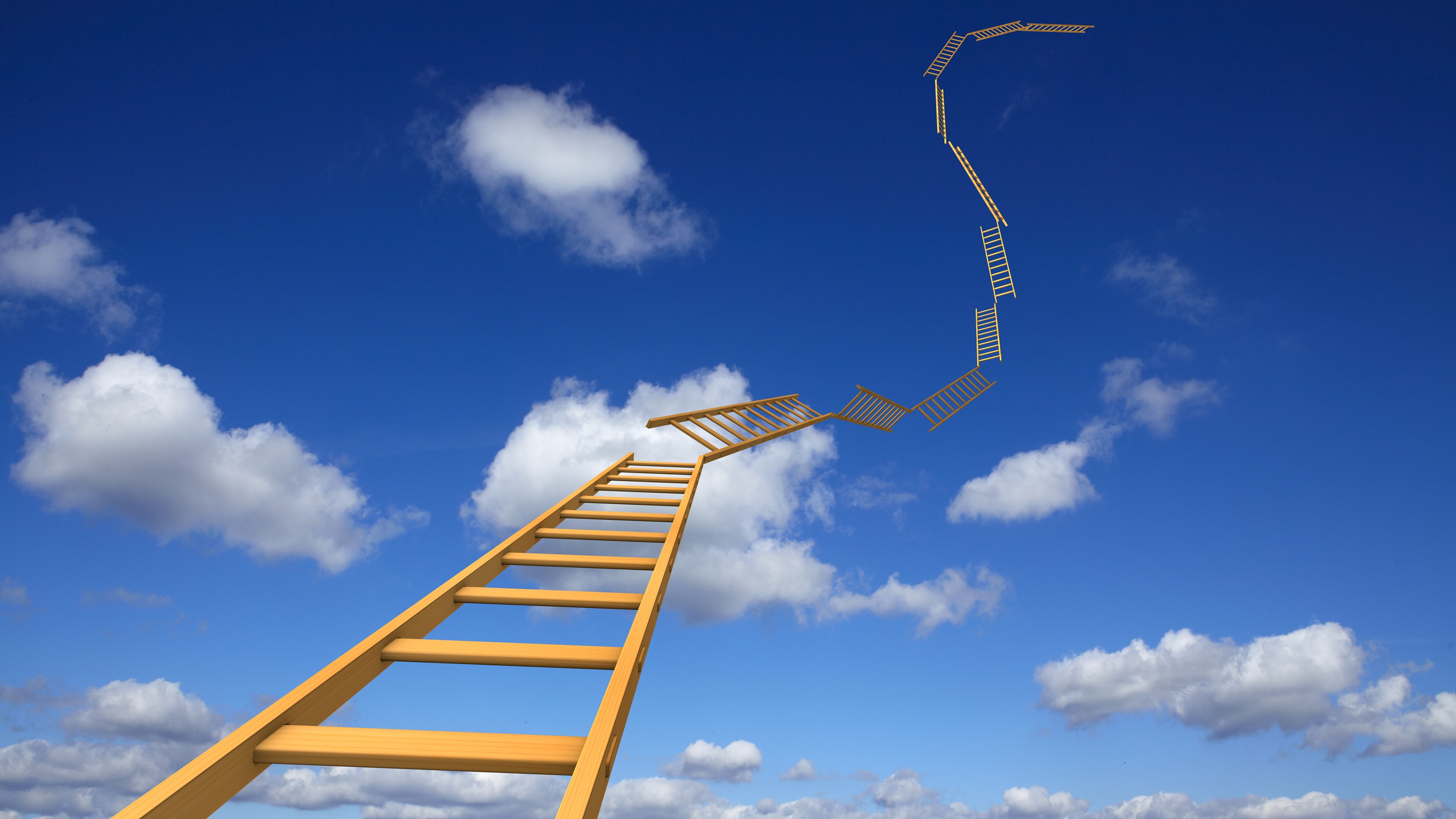 A yellow ladder with many segments reaches high into a blue sky.
