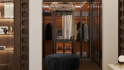 luxury closet with glass-fronted cabinets, an ottoman, display shelves and modern chandelier 