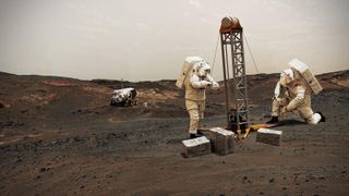 two astronauts in white spacesuits working to set up an ice-drilling rig on mars.
