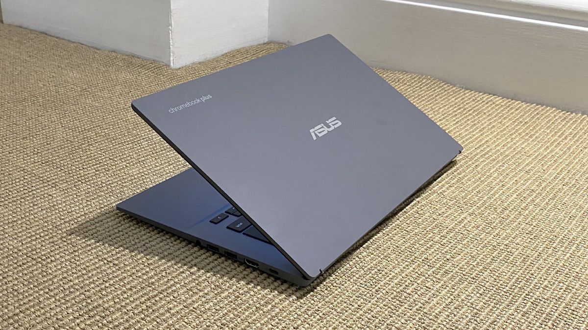 The Asus Chromebook Plus CX34 photographed on a tan carpet.