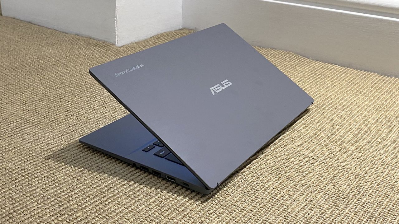 The Asus Chromebook Plus CX34 photographed on a tan carpet.