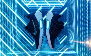 Blue neon background- Black Nike trainers in the centre