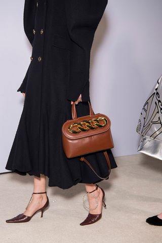 Girl holding brown handbag
