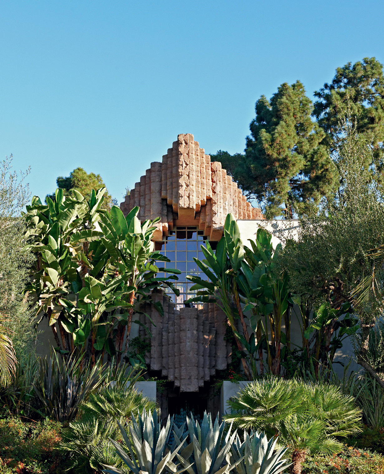 Stone exterior of building nestled in trees