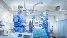 A nurse and surgeons in an operating theatre