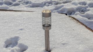 Solar lamp in the snow outdoors