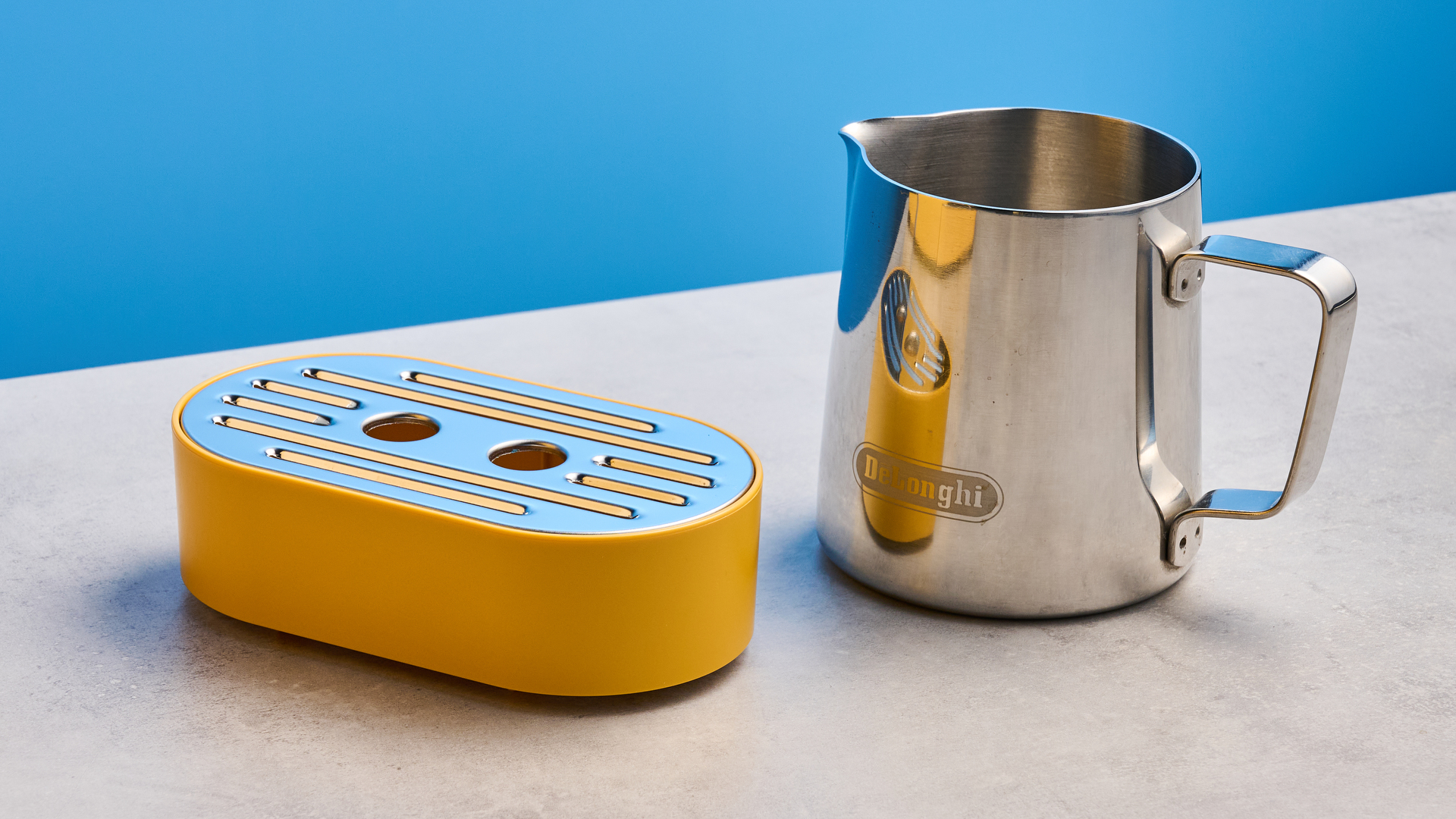 the de&#039;longhi la specialista arte evo special edition truestart edition, with yellow body, showing the espresso machine attachments like tamper, tamping collar, grinder, and control buttons