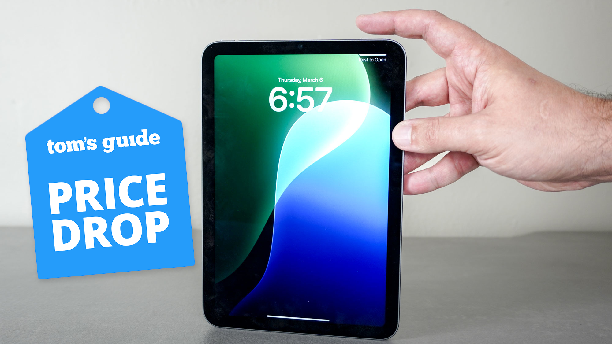 An iPad mini on a desk with a Tom's Guide Price Drop deals badge