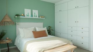 A bedroom with a mint green wall