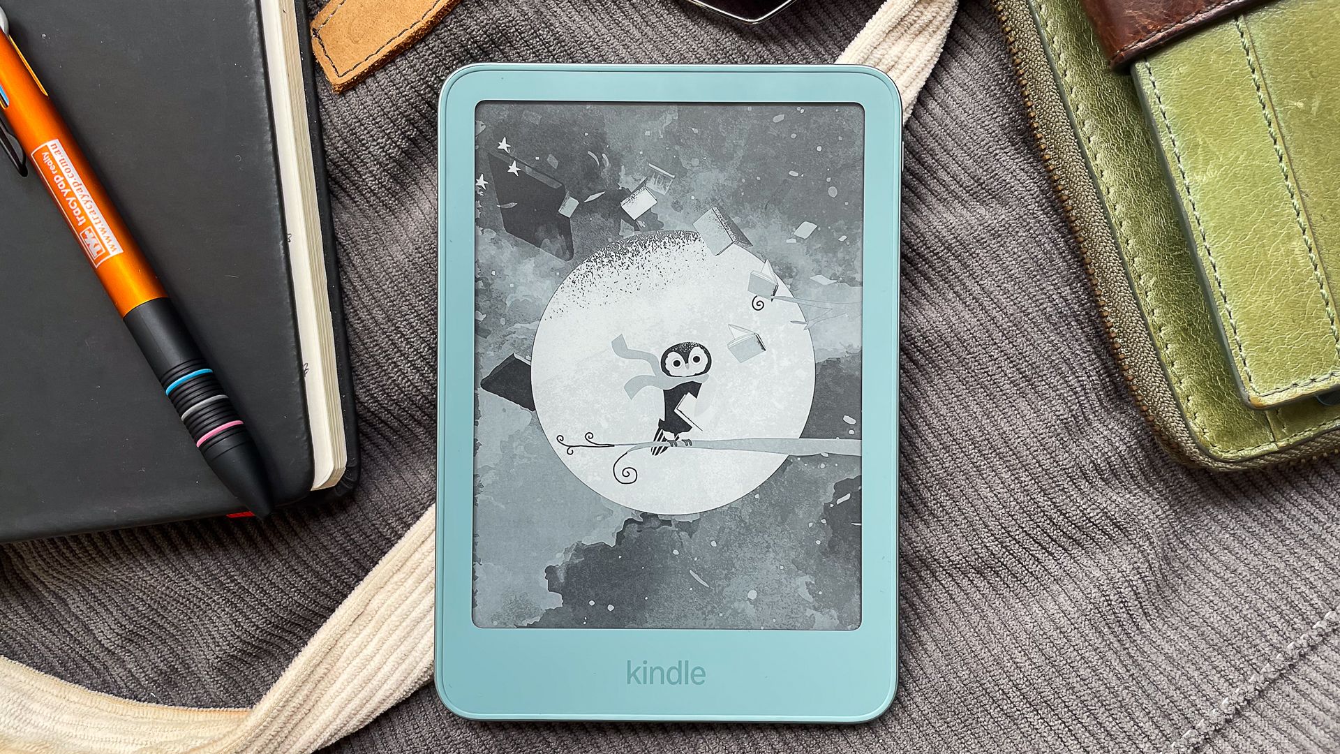 A cute wallpaper on the Amazon Kindle 2026 showing a penguin wearing a scarf