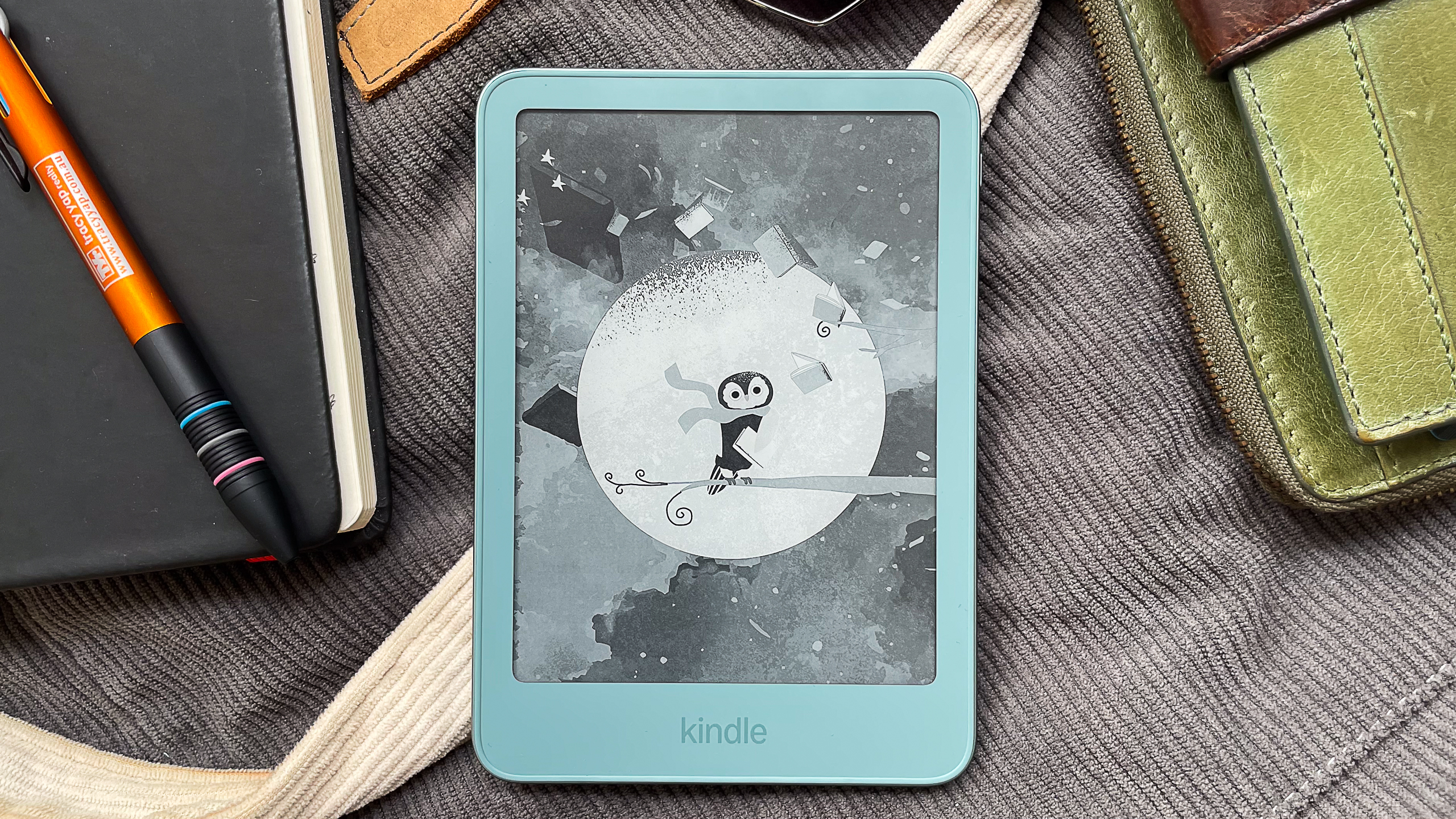 A cute wallpaper on the Amazon Kindle 2026 showing a penguin wearing a scarf