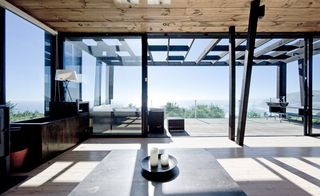 Large floor to ceiling windows linking the living room to the terrace