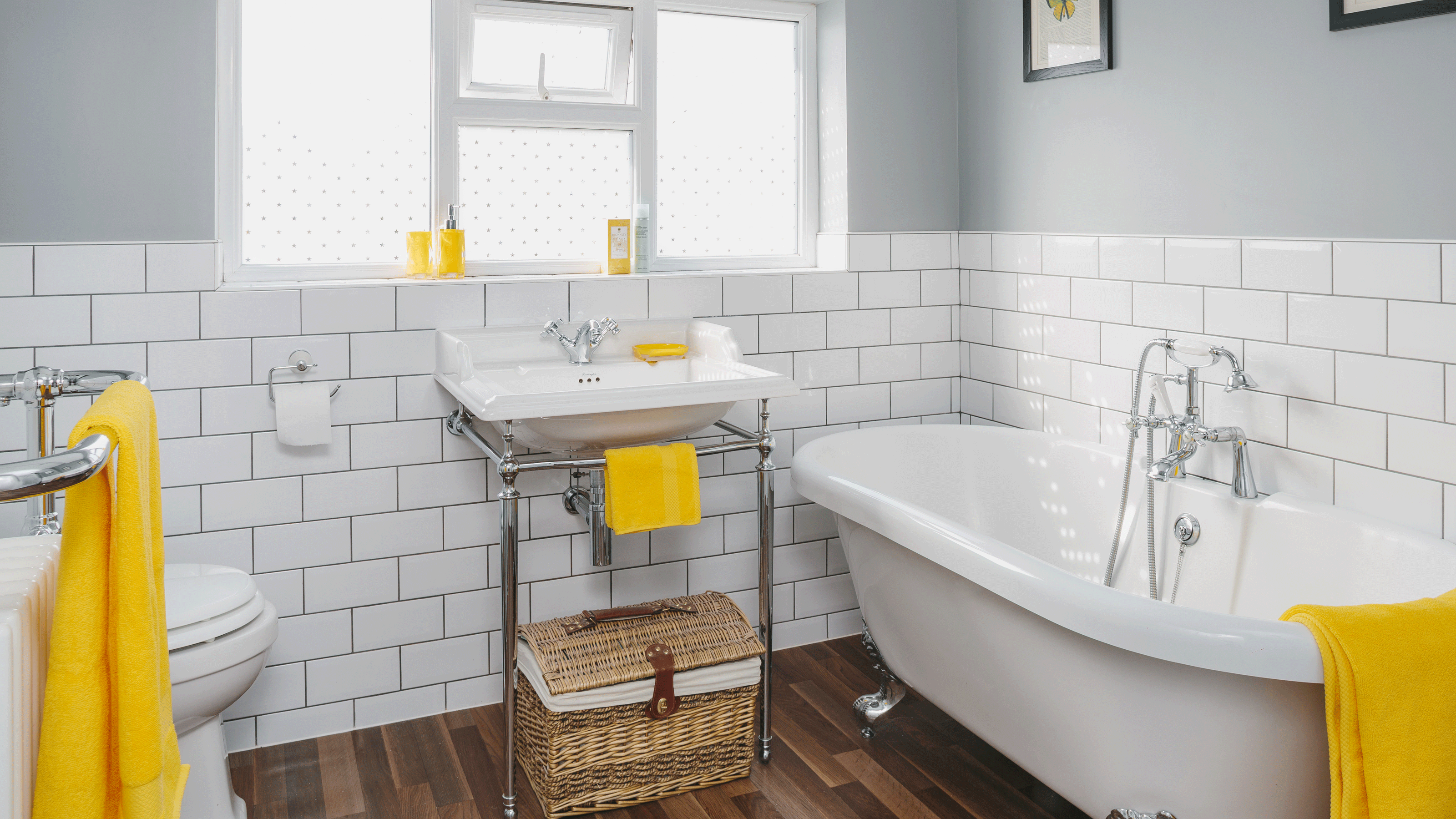 Bathroom with blue walls, white tiles and oval bath