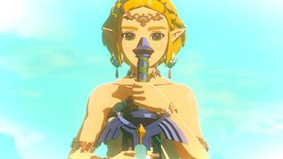 The Legend of Zelda: Tears of the Kingdom screenshot showing Princess Zelda with tied-back blonde hair and emerald green eyes, wielding a sword before her face