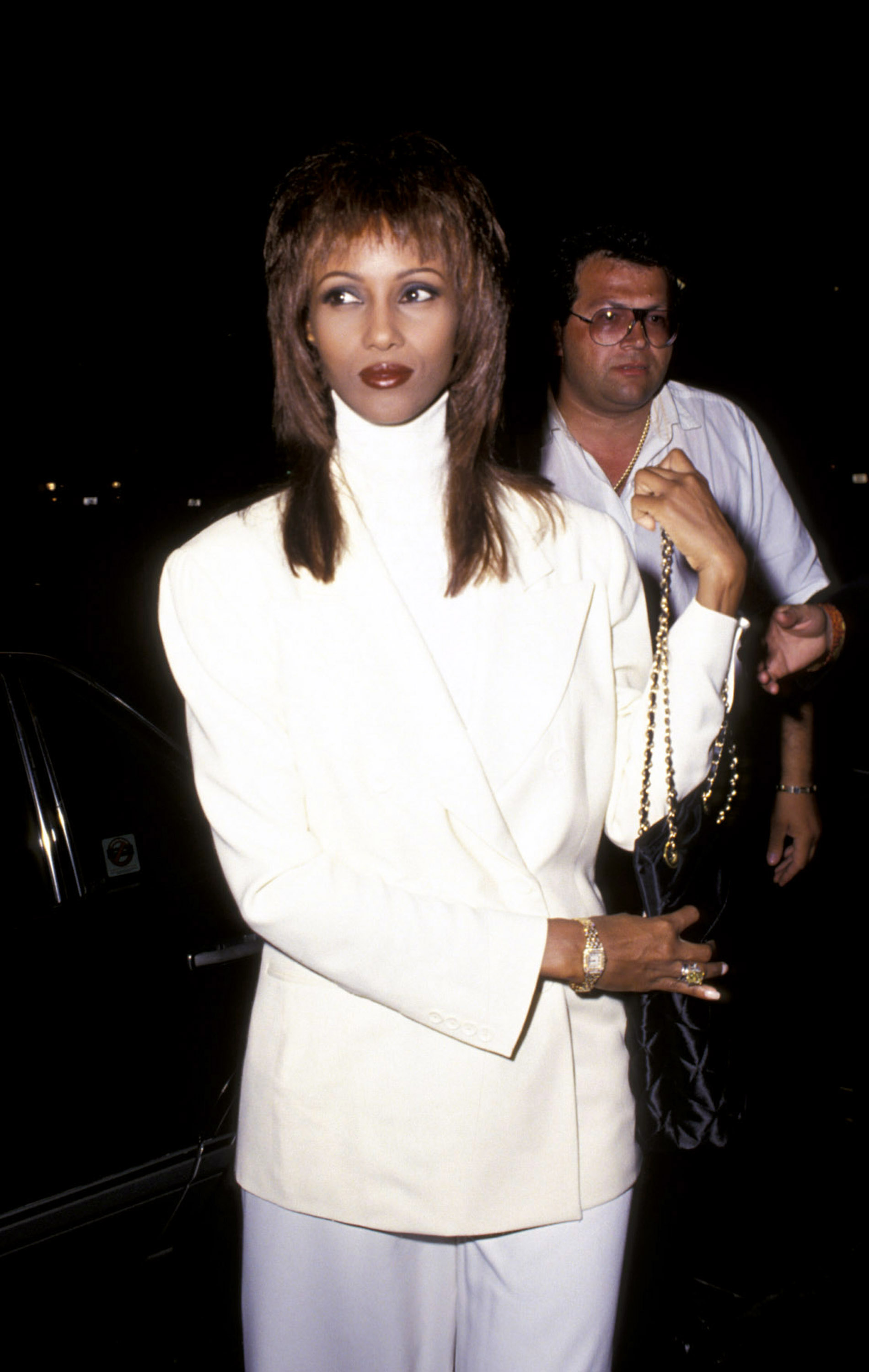 Iman wears an all white suit and white turtleneck in NYC.