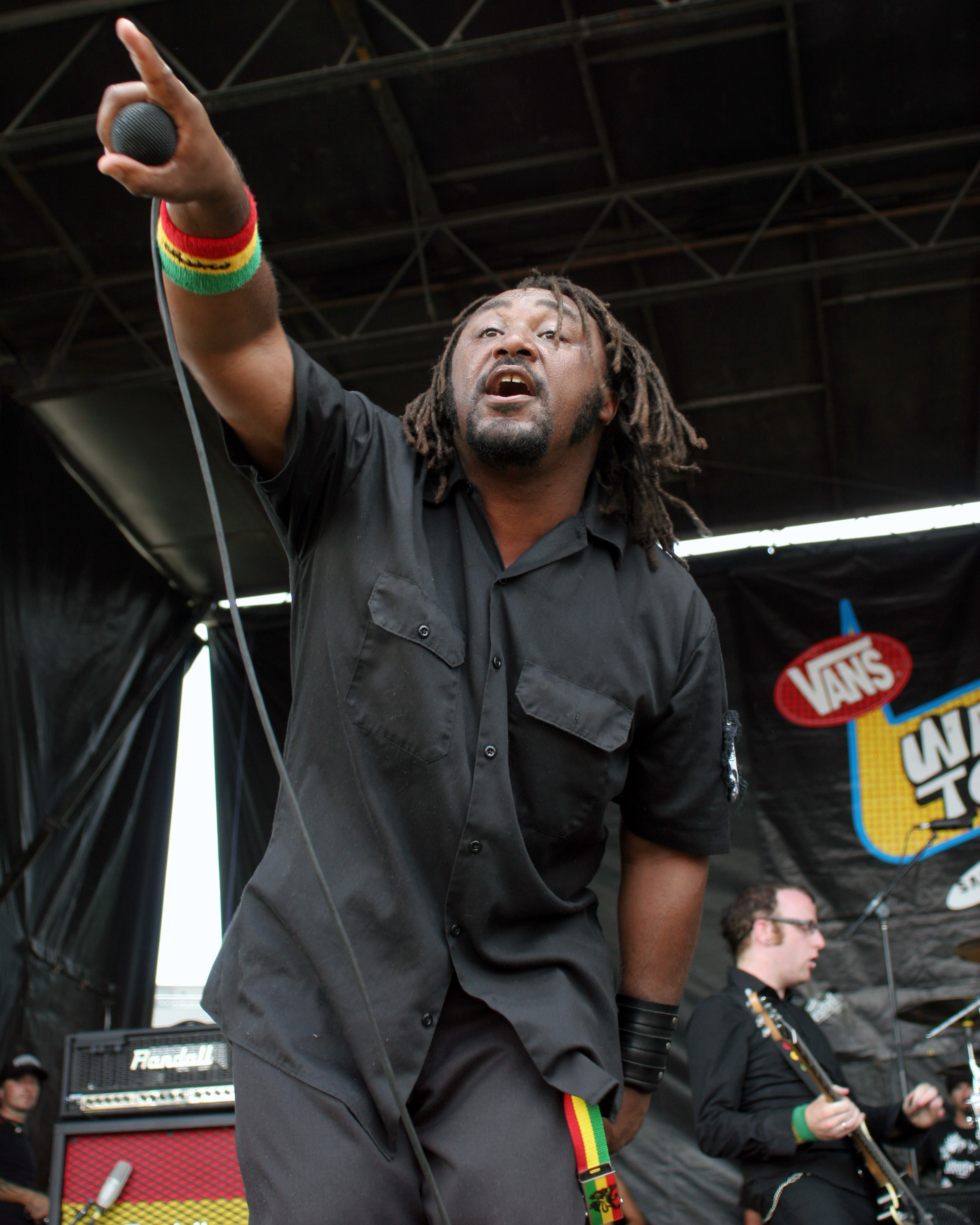 Benji Webbe shouting and pointing on stage