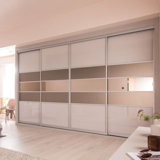 Two master wardrobes with glass panels and sliding doors