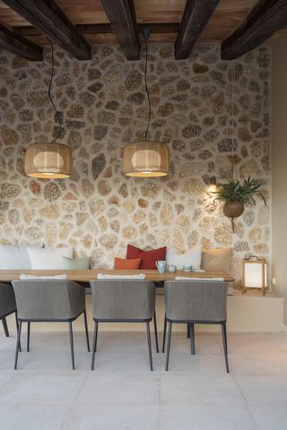A dining room with a pendant light and LED light on wall