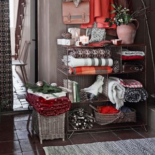 metal storage unit with clothes and throws