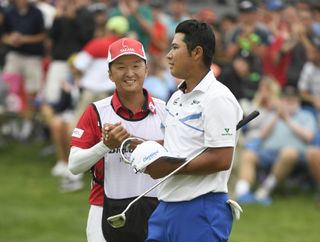 Hideki Matsuyama celebrates with his caddie Daisuke Shindo after winning the 2017 WGC Bridgestone Invitational via a playoff