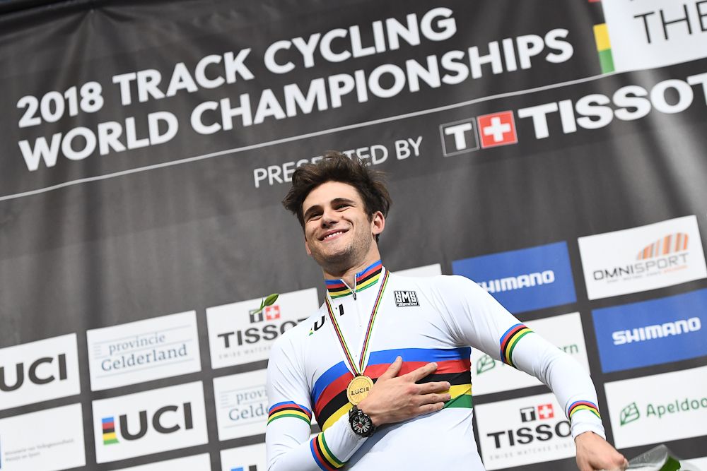 Gold medallist Italy's Filippo Ganna celebrates on the podium after the men's individual pursuit race final during the UCI Track Cycling World Championships